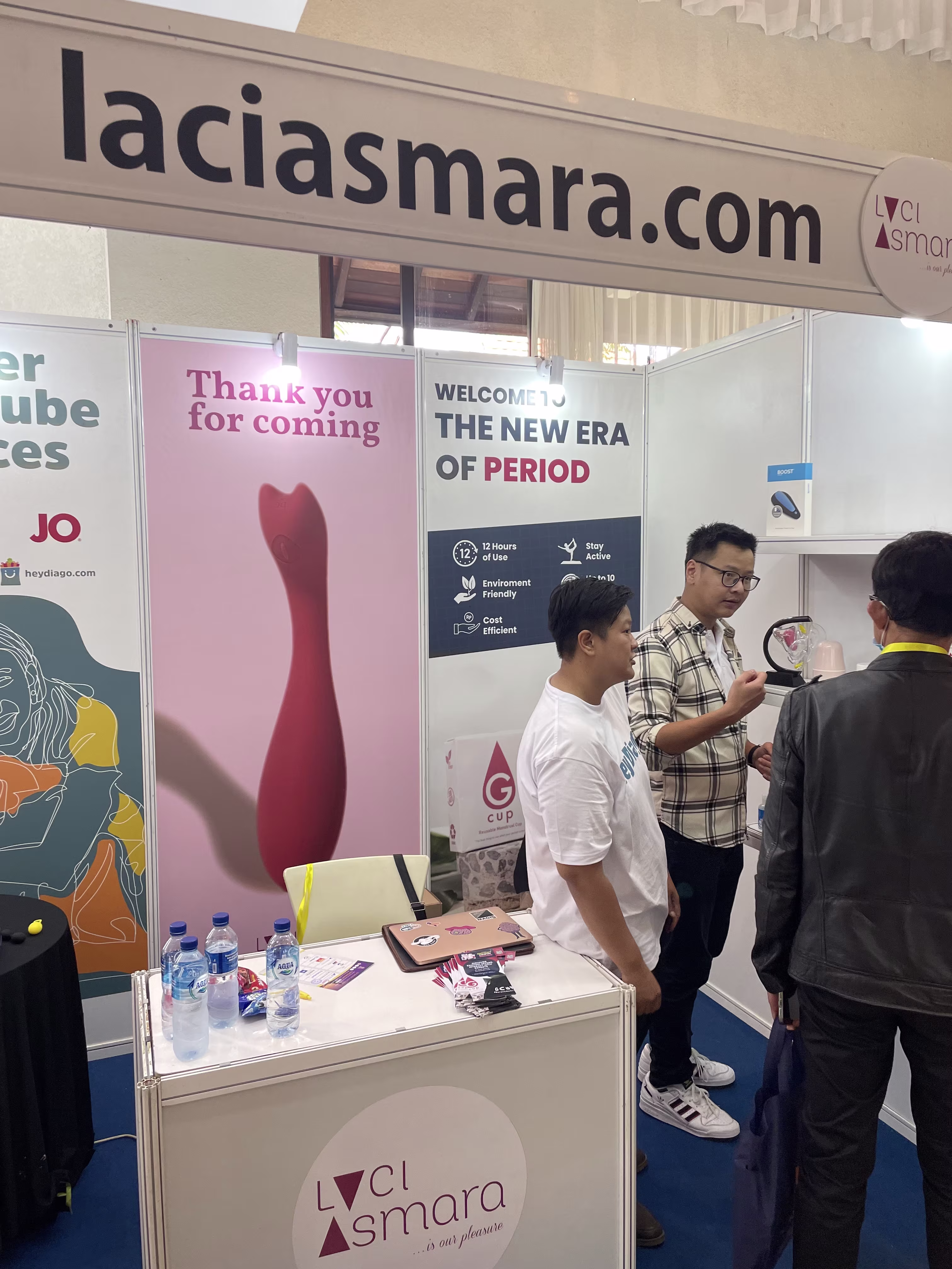 Hans from GCUP demonstrating intimate wellness products to a group of visitors at the Laciasmara booth during NASWAAM 2023