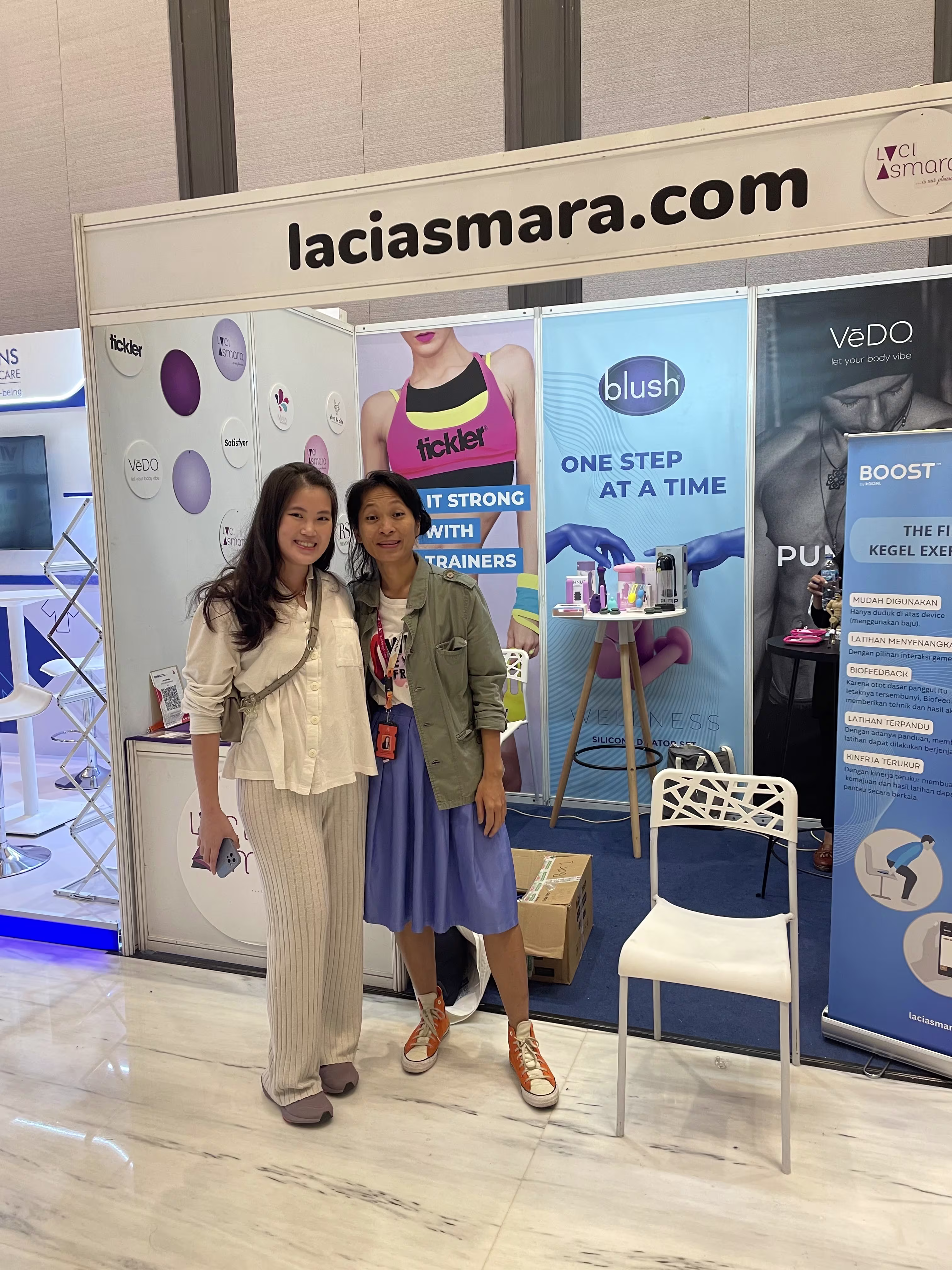dr. Michelle Octoviani with Laciasmara founder Rendra Susanti standing in front of the booth at Kongres Nasional IV Asosiasi Seksologi Indonesia