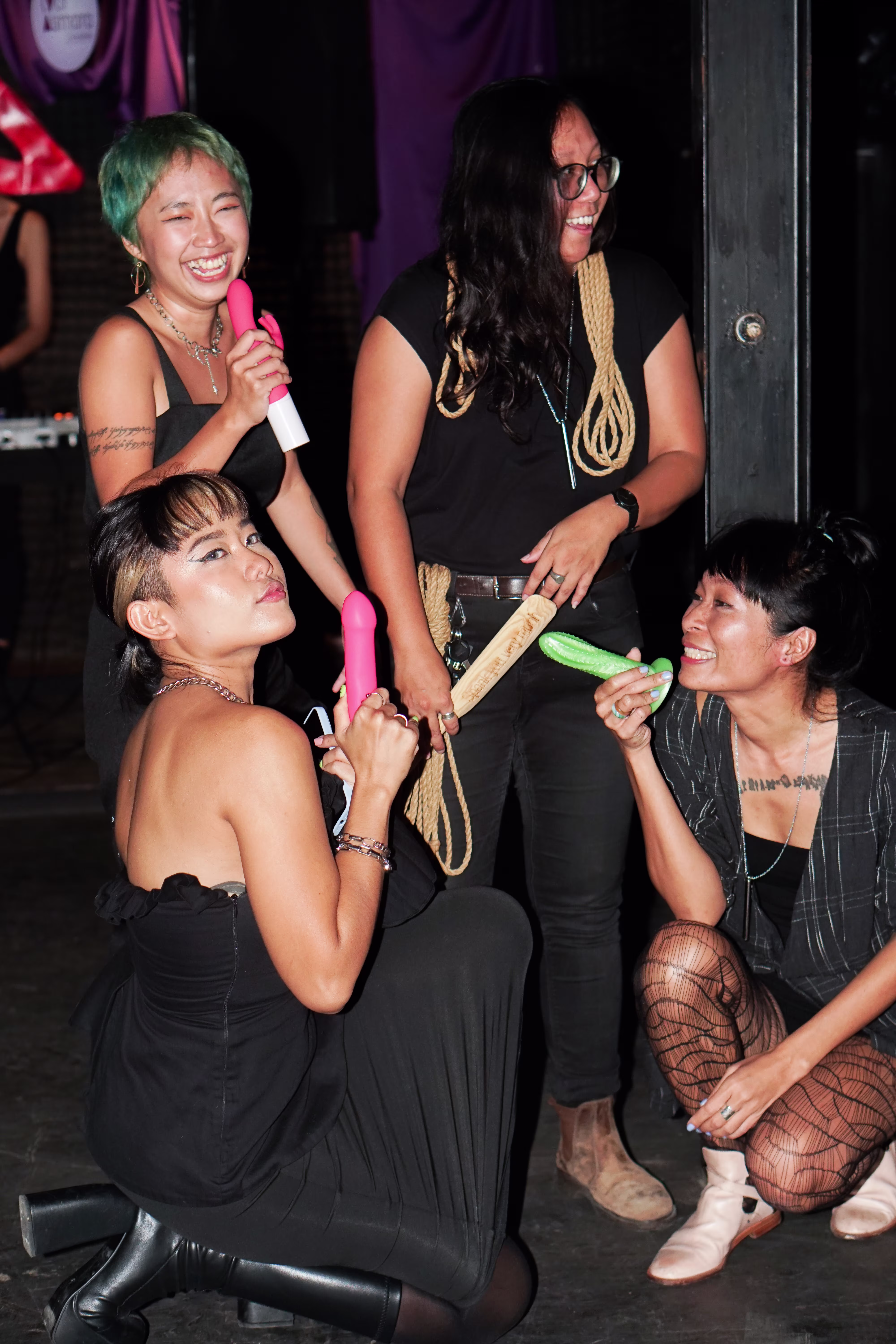 Laciasmara founder Rendra Susanti posing with three Asmaradoor ambassadors holding educational sexual wellness models at the Tingle and Mingle Party at Joshua District