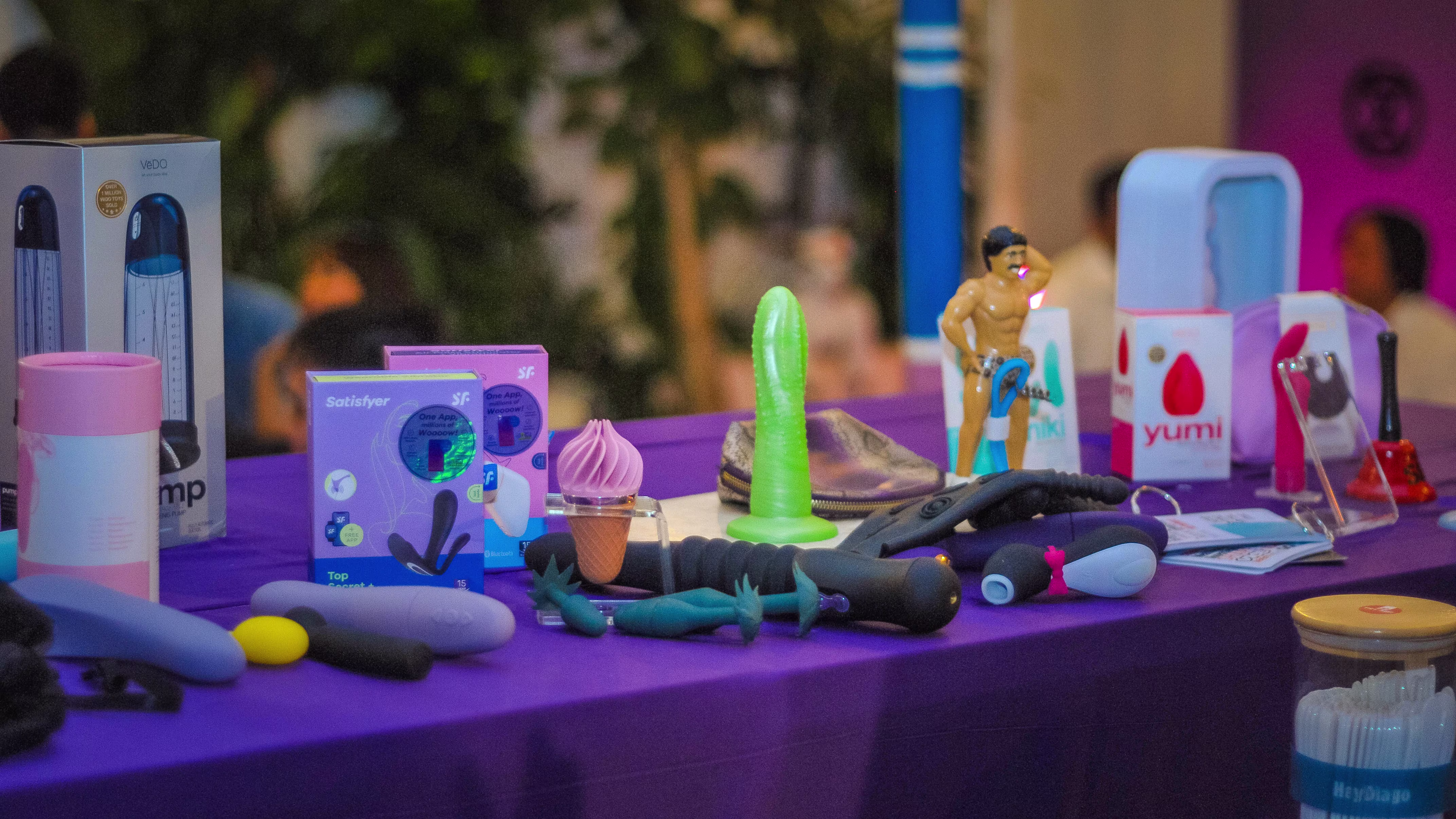 A beautifully arranged sexual wellness product display showcase on a table at the Laciasmara 7th anniversary party at ¡Porqué No!