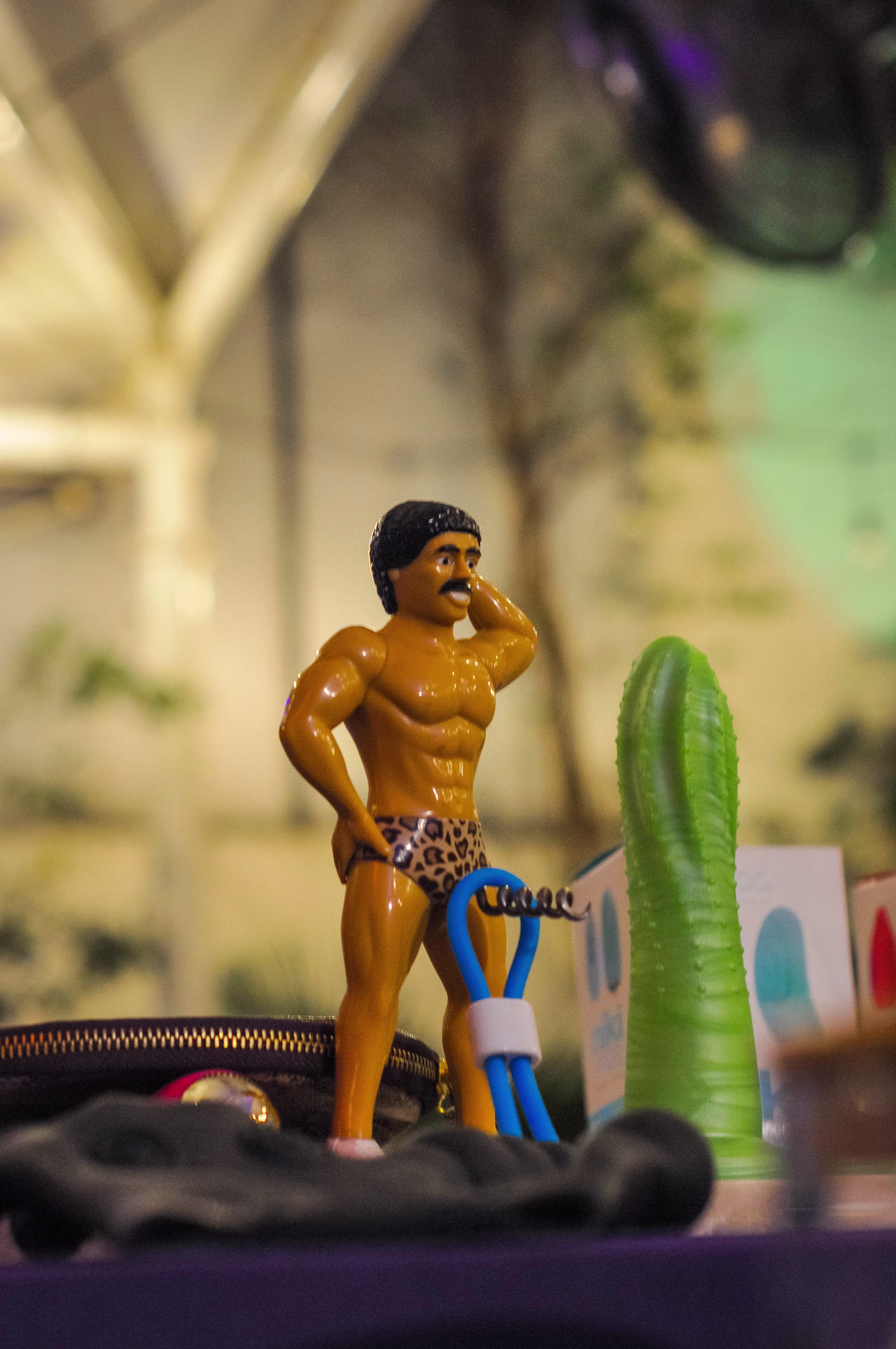 A Tickler Buddy Erection Holder displayed creatively on a male anatomical novelty figure at the Laciasmara 7th anniversary event
