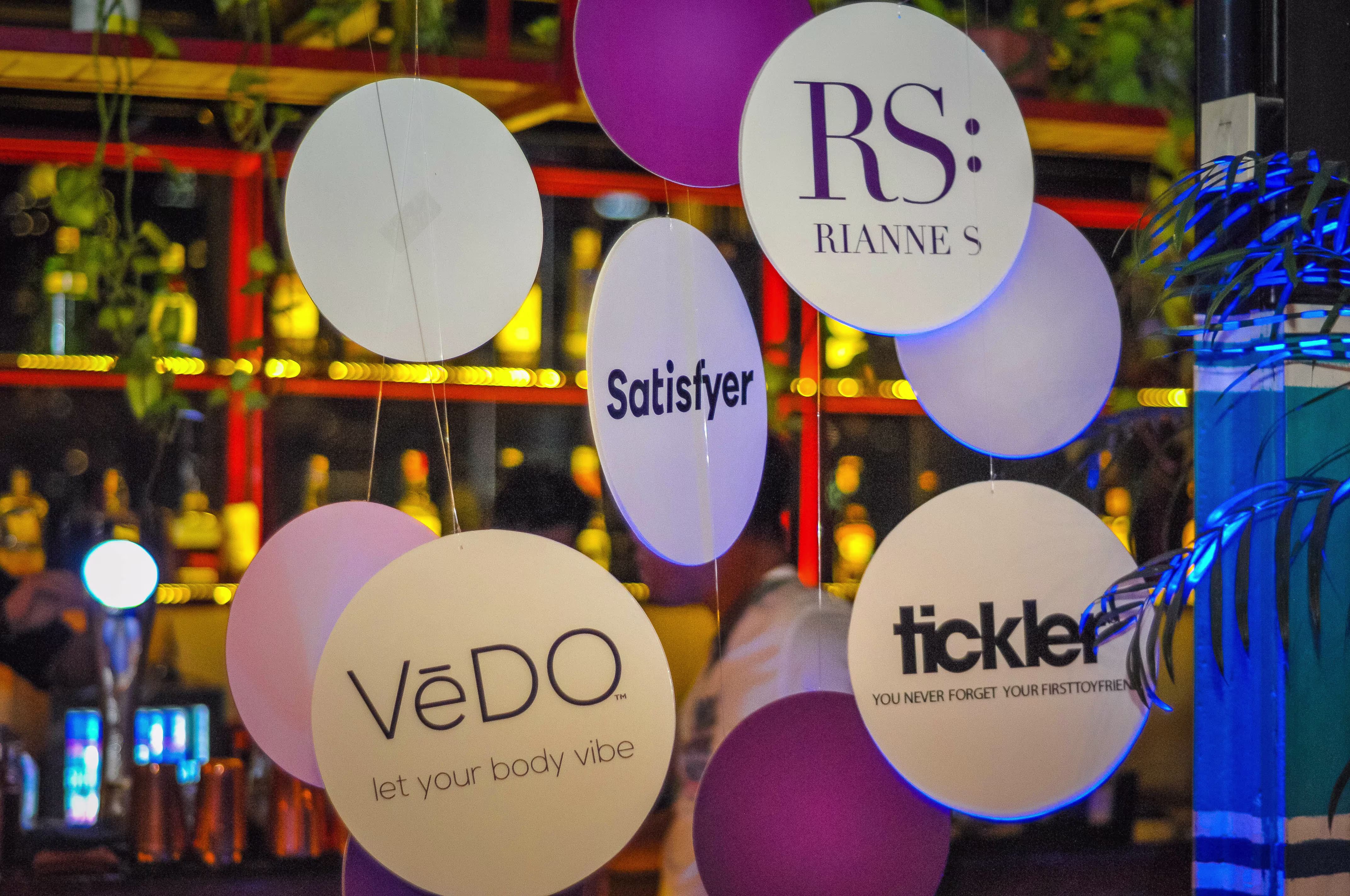 A stylish circular branded hanger curtain displaying the Laciasmara logo as part of the venue's anniversary event decor