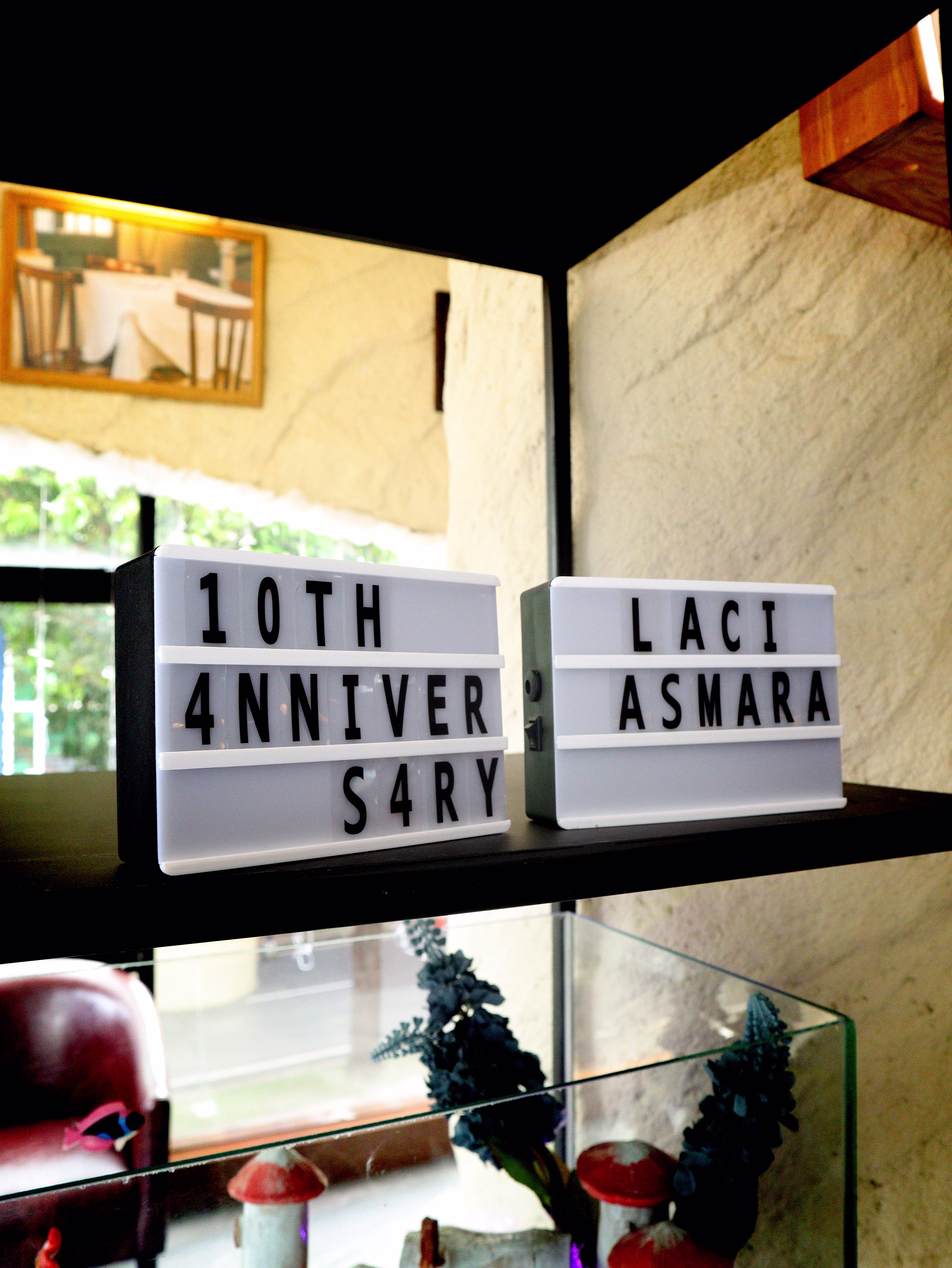 A custom LED light sign glowing with the text '10th Anniversary Laciasmara'.